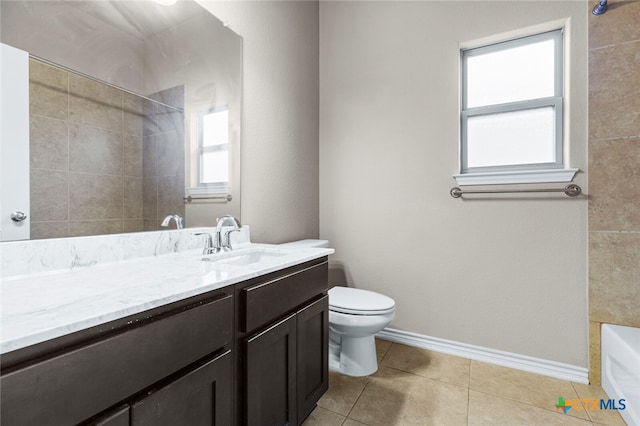 full bathroom featuring tile patterned floors, vanity, toilet, and tiled shower / bath combo