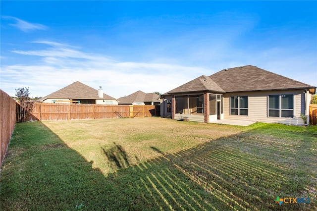 back of house featuring a lawn