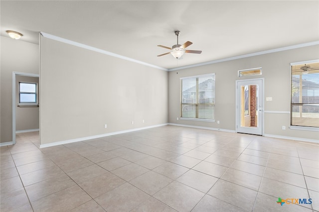 spare room featuring crown molding, plenty of natural light, and ceiling fan