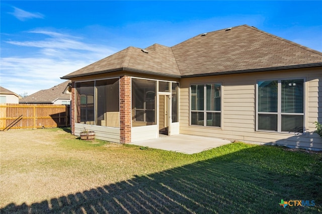 back of house featuring a sunroom, a patio area, and a yard