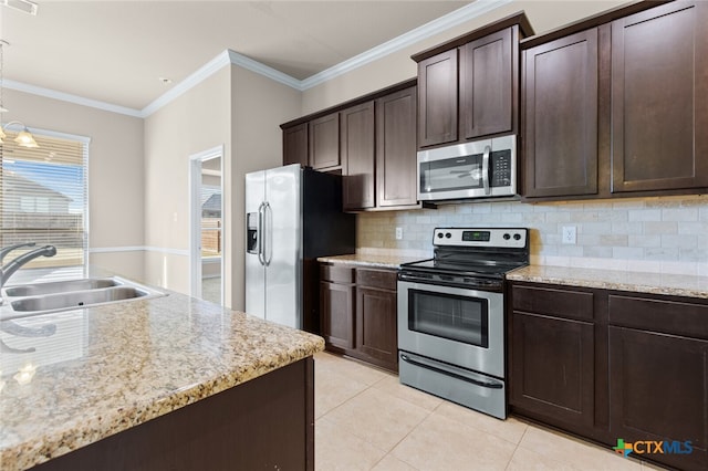 kitchen featuring dark brown cabinetry, crown molding, sink, and stainless steel appliances