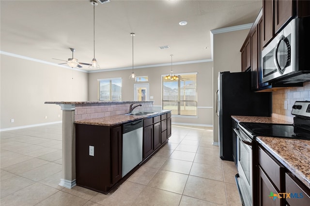 kitchen featuring tasteful backsplash, a wealth of natural light, dark brown cabinets, and appliances with stainless steel finishes