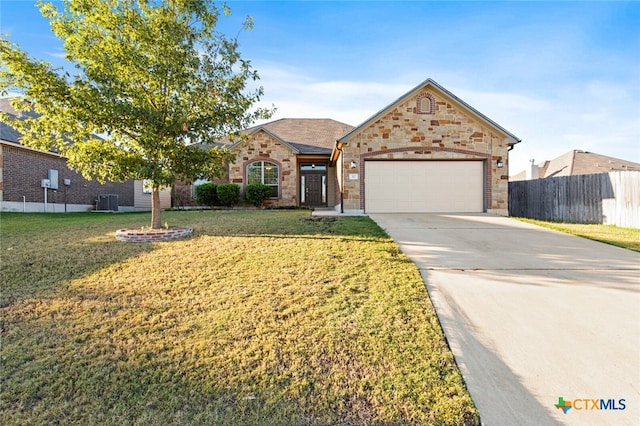 ranch-style home with cooling unit, a front lawn, and a garage