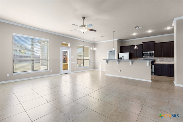 unfurnished living room featuring plenty of natural light, light tile patterned floors, and ornamental molding