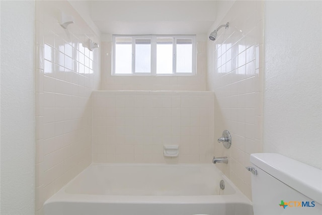 full bath featuring toilet, shower / bathing tub combination, and a textured wall