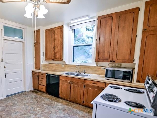 608 N Clinton St, Cuero, TX 77954 - kitchen with black dishwasher, electric stove, stainless steel microwave, and light countertops