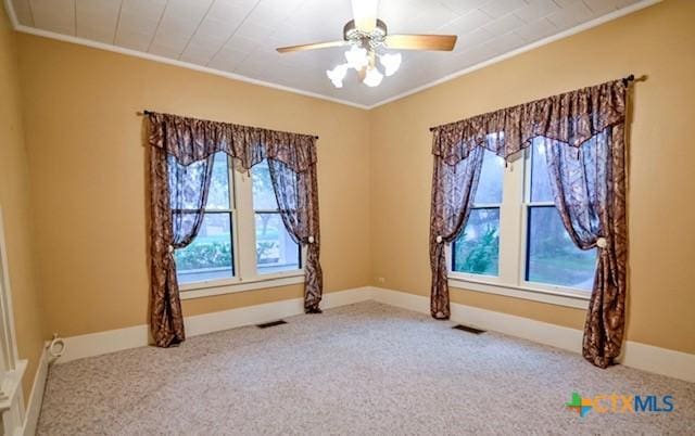 608 N Clinton St, Cuero, TX 77954 - carpeted empty room featuring crown molding and a ceiling fan