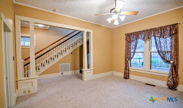 608 N Clinton St, Cuero, TX 77954 - unfurnished room with stairway, a ceiling fan, carpet, and ornamental molding