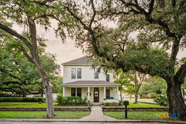 608 N Clinton St, Cuero, TX 77954 - view of front of property with covered porch and a front yard