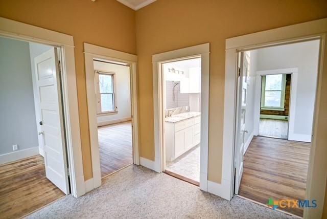 608 N Clinton St, Cuero, TX 77954 - hall with plenty of natural light and wood finished floors