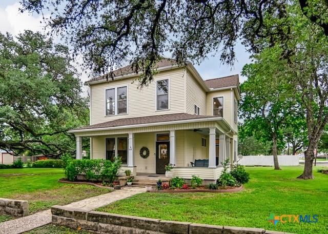 608 N Clinton St, Cuero, TX 77954 - view of front of house featuring a front lawn and covered porch