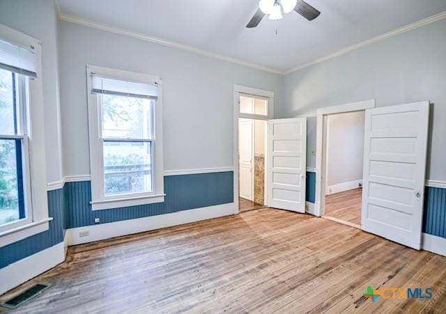 608 N Clinton St, Cuero, TX 77954 - unfurnished bedroom with ornamental molding, wood finished floors, and ceiling fan