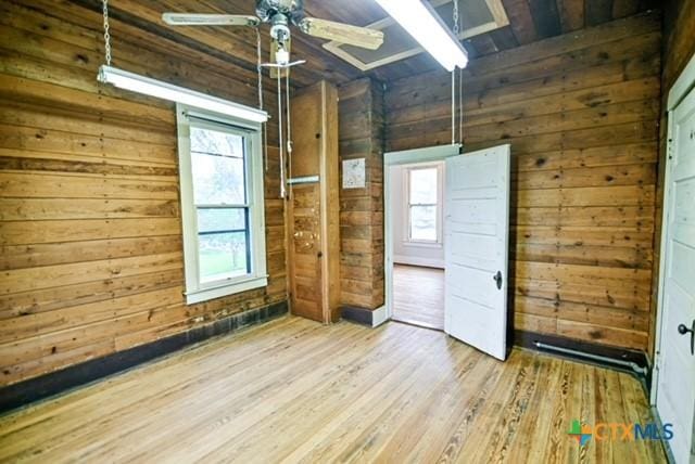 608 N Clinton St, Cuero, TX 77954 - unfurnished room featuring wood walls, wood finished floors, and a ceiling fan