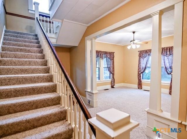 608 N Clinton St, Cuero, TX 77954 - staircase with ceiling fan, decorative columns, crown molding, and carpet