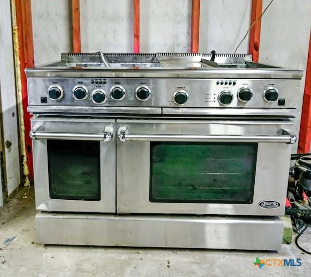 608 N Clinton St, Cuero, TX 77954 - kitchen view of unfinished concrete flooring and range with two ovens