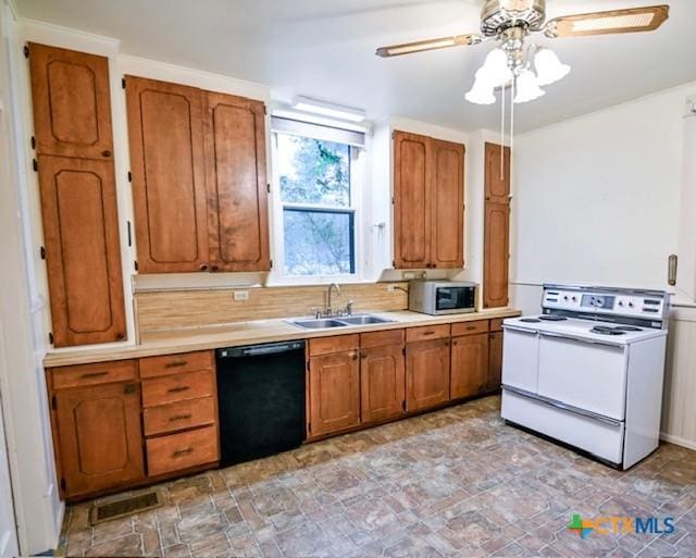 608 N Clinton St, Cuero, TX 77954 - kitchen with dishwasher, white electric range oven, stainless steel microwave, and brown cabinetry