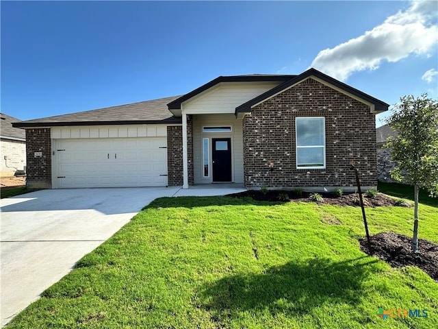 view of front of property with a garage and a front lawn