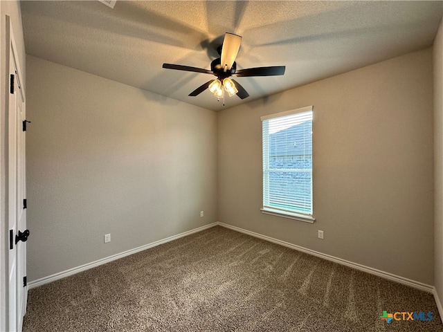 carpeted spare room featuring ceiling fan and a textured ceiling