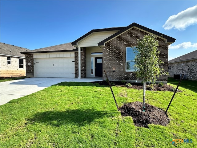 view of front of property with a garage and a front yard