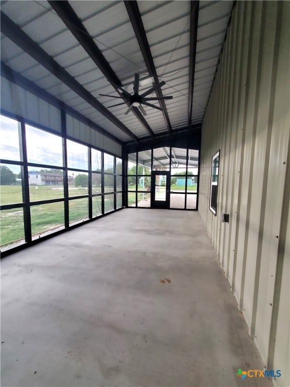 unfurnished sunroom with lofted ceiling with beams