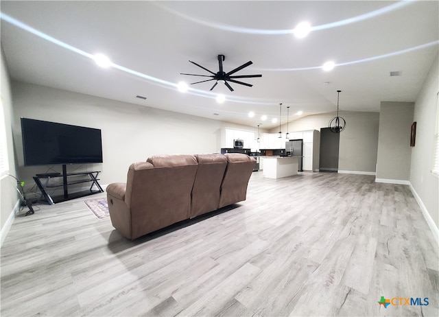 living room with light wood-type flooring, lofted ceiling, and ceiling fan