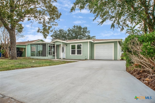 single story home with a garage and a front lawn