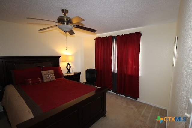 carpeted bedroom featuring a textured ceiling and ceiling fan