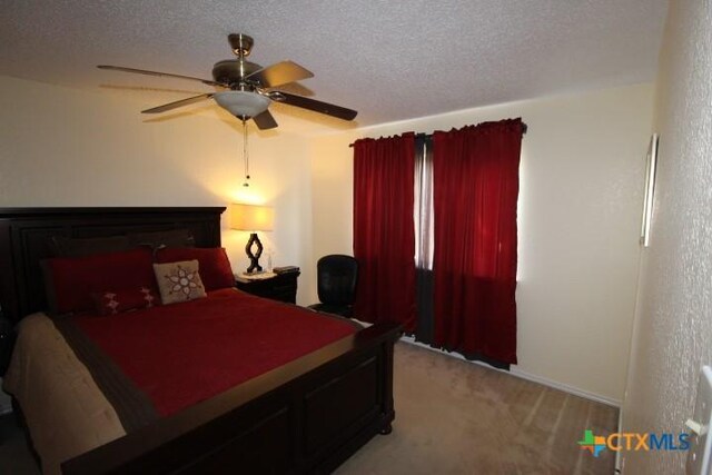 2305 Chestnut Dr, Killeen, TX 76543 - bedroom featuring light carpet, a textured ceiling, ceiling fan, and baseboards