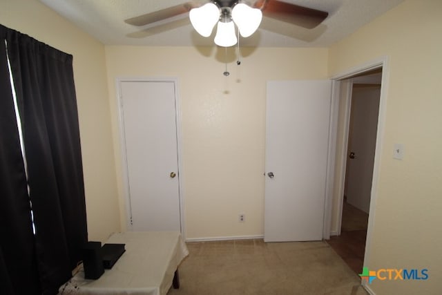 bedroom featuring light carpet and ceiling fan