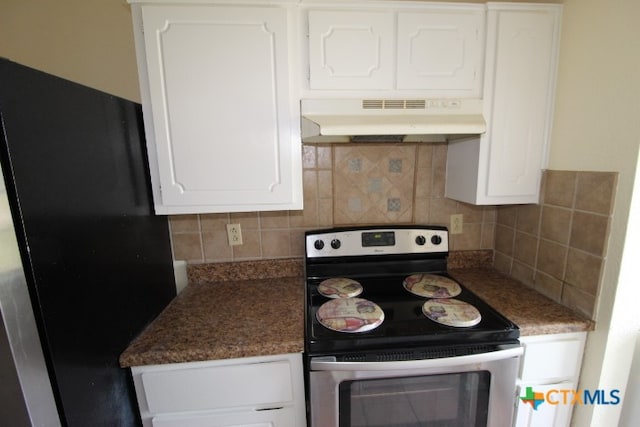 kitchen featuring black fridge, electric stove, white cabinets, decorative backsplash, and ventilation hood