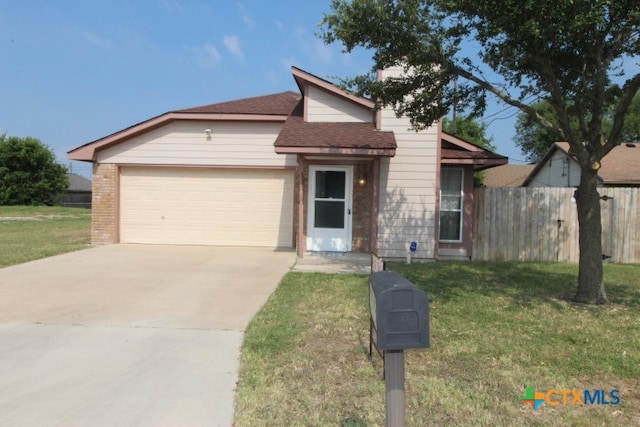 view of front of home featuring a garage and a front lawn