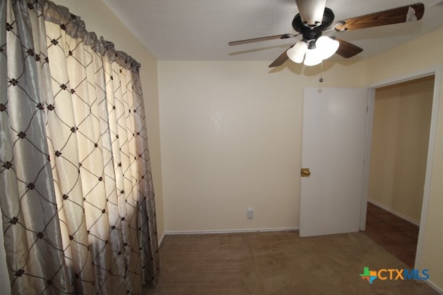 empty room featuring carpet and ceiling fan