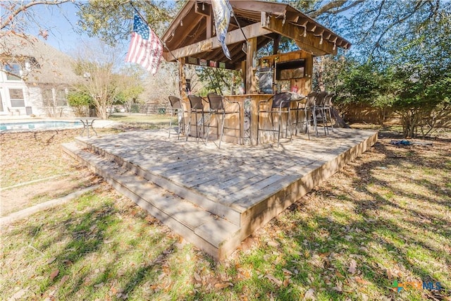 view of patio / terrace featuring a pool side deck and an outdoor bar