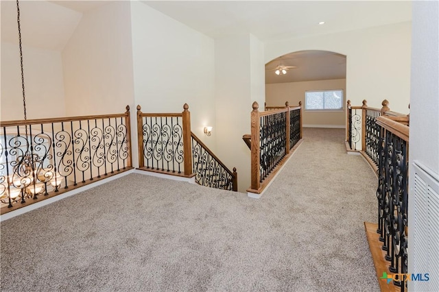 hallway featuring light colored carpet