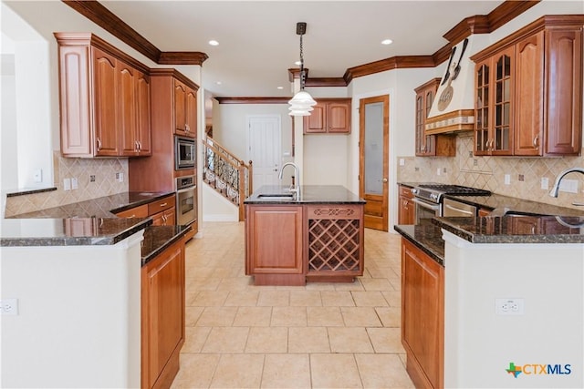 kitchen with stainless steel appliances, custom range hood, sink, and hanging light fixtures