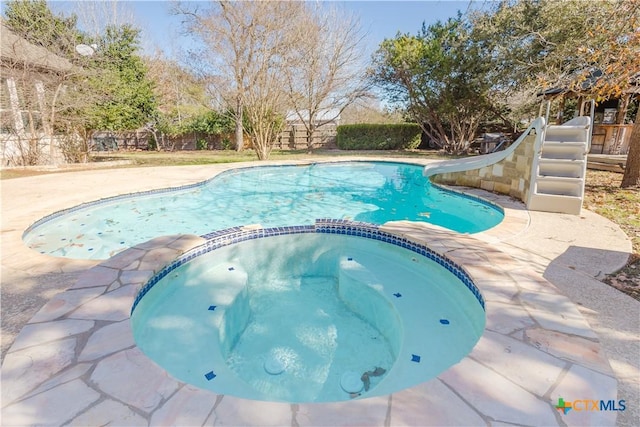 view of pool featuring an in ground hot tub and a patio area