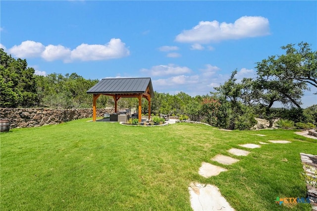 view of community featuring a gazebo, a yard, and an outdoor living space