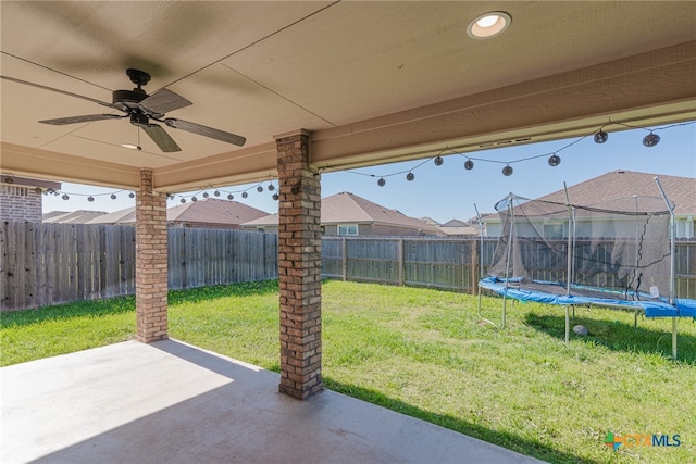 view of patio / terrace with ceiling fan and a trampoline