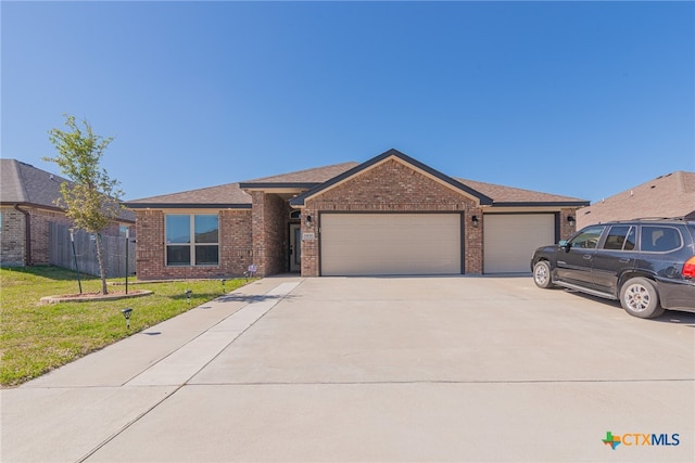 single story home featuring a front lawn and a garage