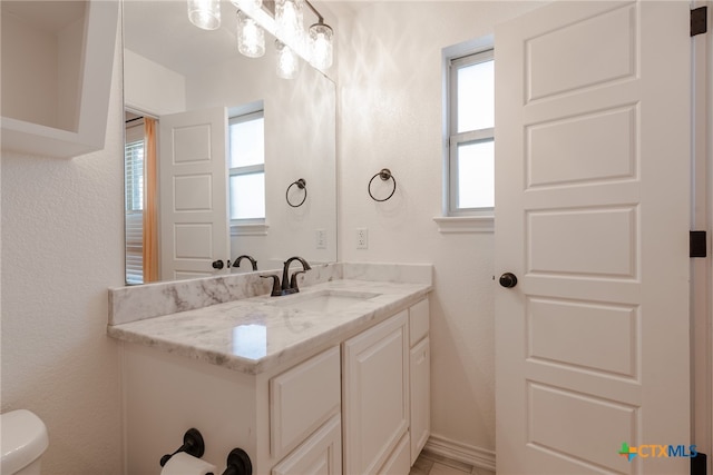 bathroom featuring vanity and toilet