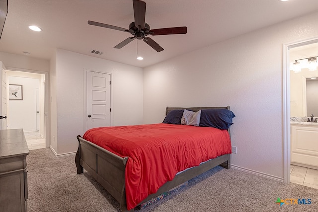 bedroom with ensuite bathroom, carpet flooring, ceiling fan, and sink