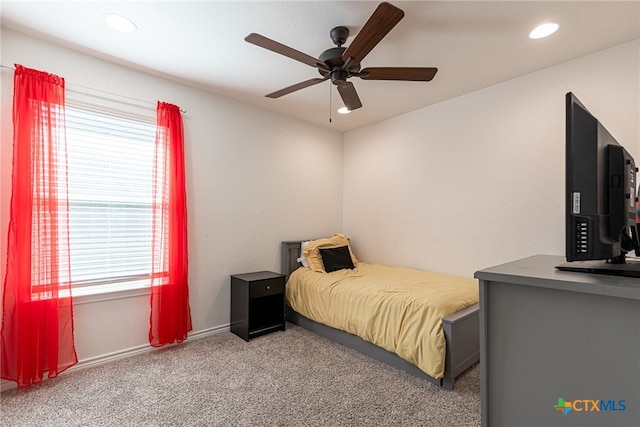 bedroom with light carpet and ceiling fan