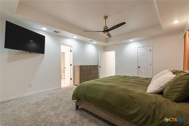 carpeted bedroom featuring ceiling fan, ornamental molding, and a tray ceiling