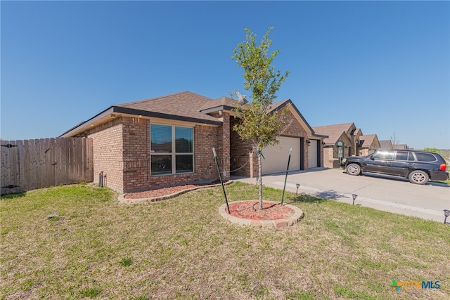 view of front of house with a garage and a front yard