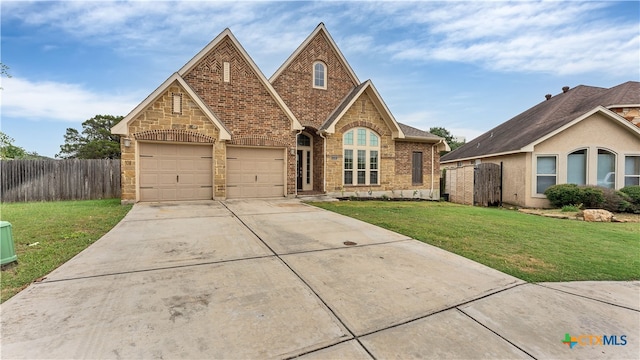 view of front of property with a garage and a front lawn