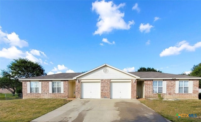 ranch-style home featuring a garage and a front lawn