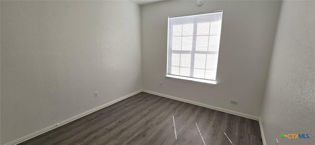 spare room featuring dark hardwood / wood-style floors