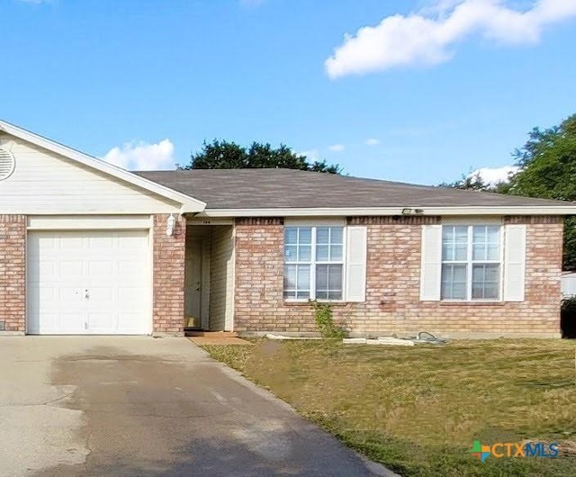 ranch-style house featuring a garage and a front yard