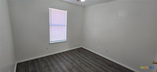 empty room featuring dark hardwood / wood-style floors and ceiling fan