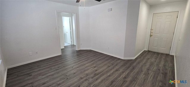 spare room with dark wood-type flooring and ceiling fan